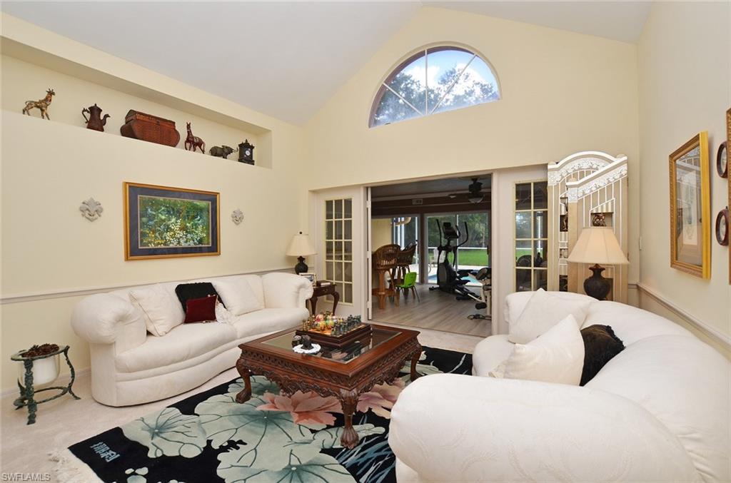 264 Henley Drive Naples, FL 34104 - Photo 7 of 25 a living room with furniture and a table