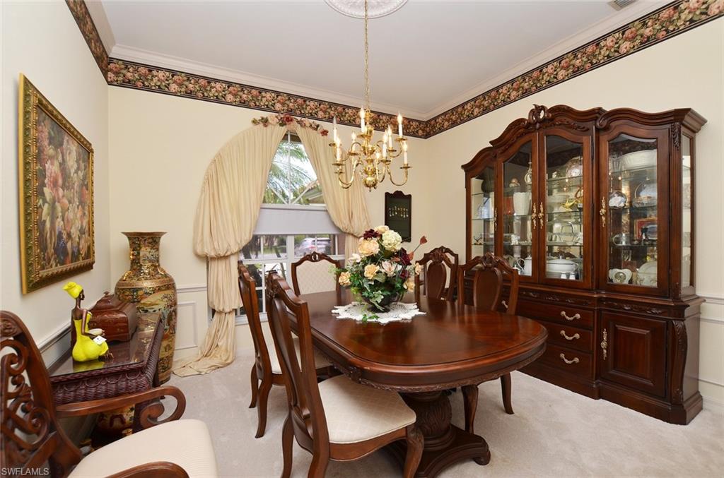264 Henley Drive Naples, FL 34104 - Photo 9 of 25 a view of a dining room with furniture and chandelier