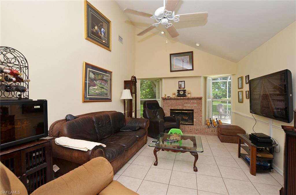 264 Henley Drive Naples, FL 34104 - Photo 10 of 25 a living room with furniture and a flat screen tv
