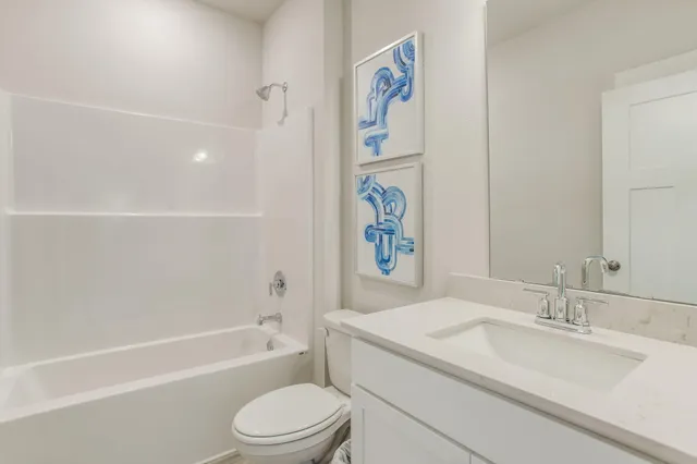 a bathroom with a granite countertop sink a toilet and bathtub