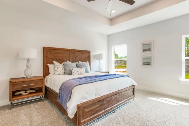 a bed sitting in a bedroom next to a window