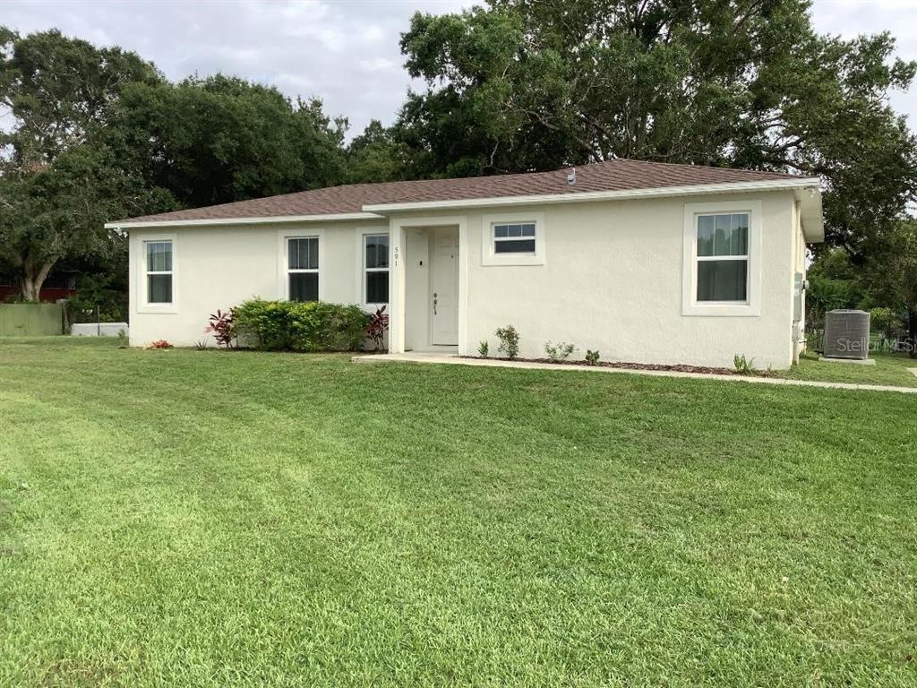 a backyard of a house with table and chairs