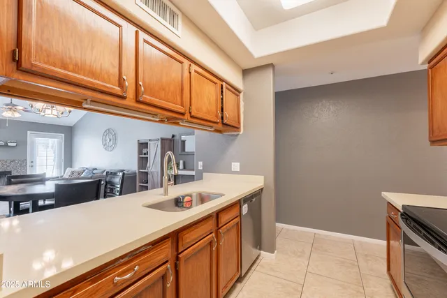 a kitchen with stainless steel appliances granite countertop a sink and cabinets