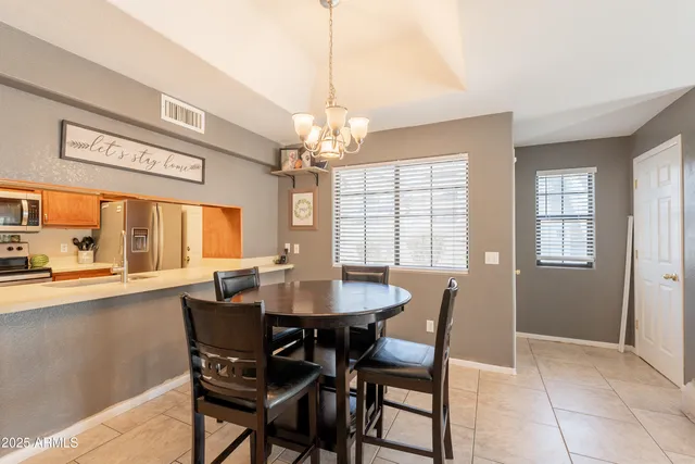 a dining room with furniture a chandelier and window