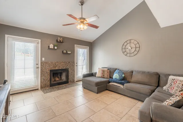 a living room with furniture and a dining table with kitchen countertops