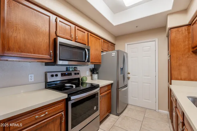 a kitchen with stainless steel appliances granite countertop a sink and cabinets