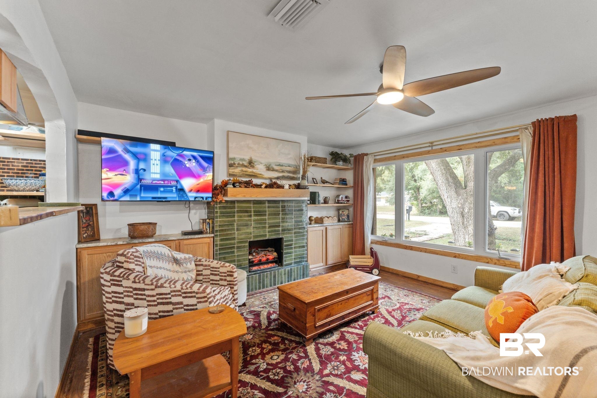 10785 Gregg Road Semmes, AL 36575 - Photo 10 of 35 Living room with a tiled fireplace, wood finished floors, and ceiling fan