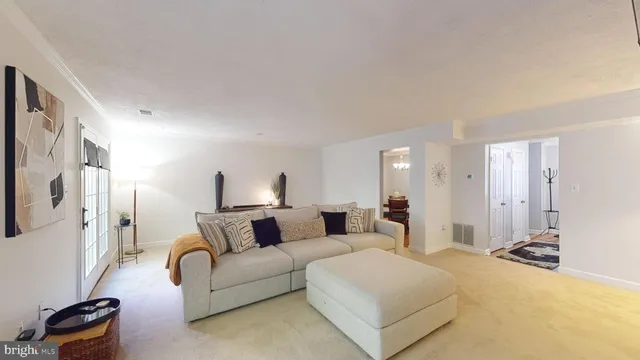 a dining room with wooden floor a chandelier a wooden table and chairs