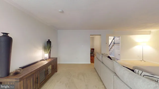 a dining room with wooden floor a chandelier a wooden table and chairs