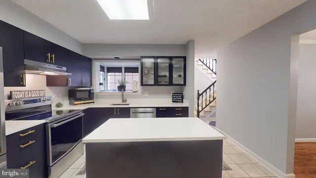 a view of a workspace with furniture and a lamp