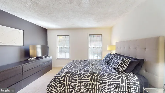 a bathroom with a granite countertop toilet a sink and a mirror
