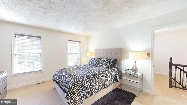 a bedroom with a bed and a rug