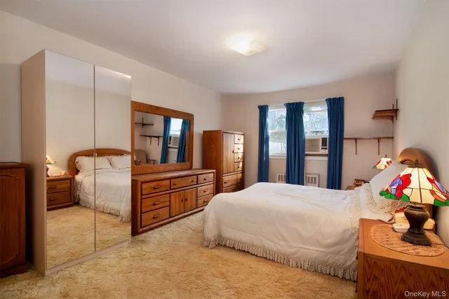 a bedroom with a bed and dresser