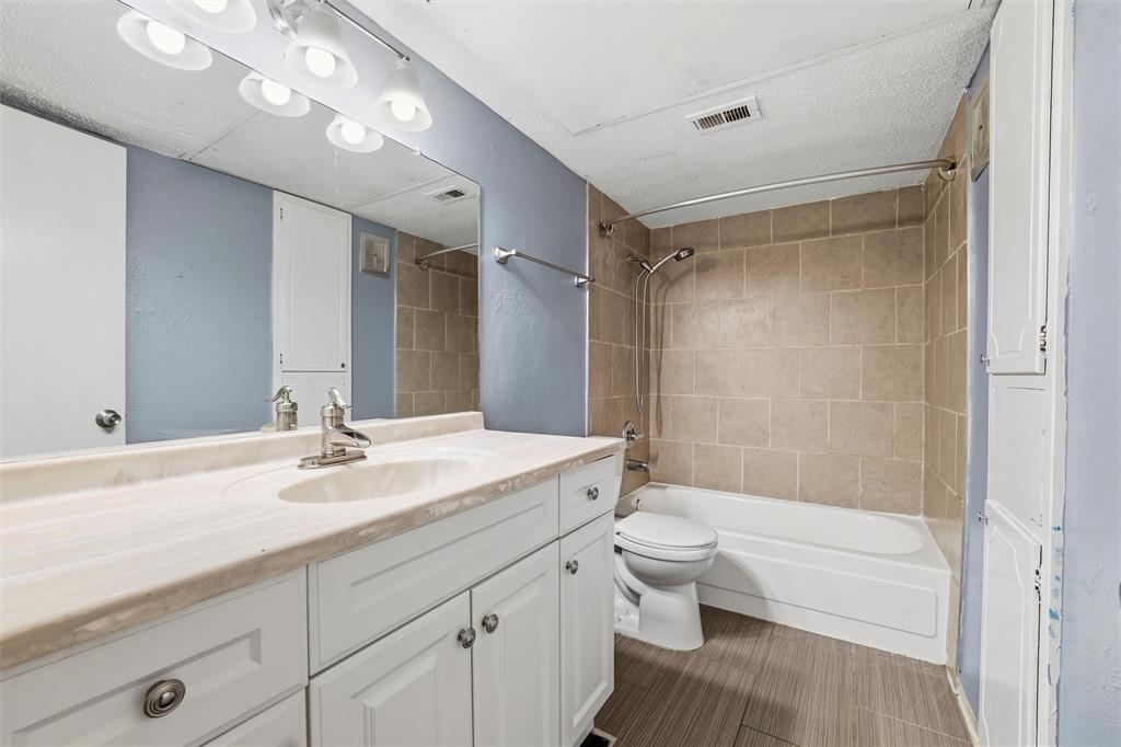 5604 Boca Raton Boulevard, Unit 248 Fort Worth, TX 76112 - Photo 15 of 25 a bathroom with a sink a toilet and shower
