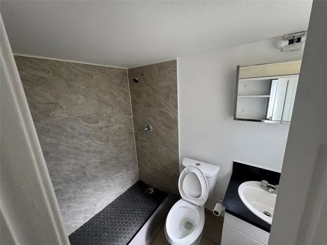 a bathroom with a toilet and a shower