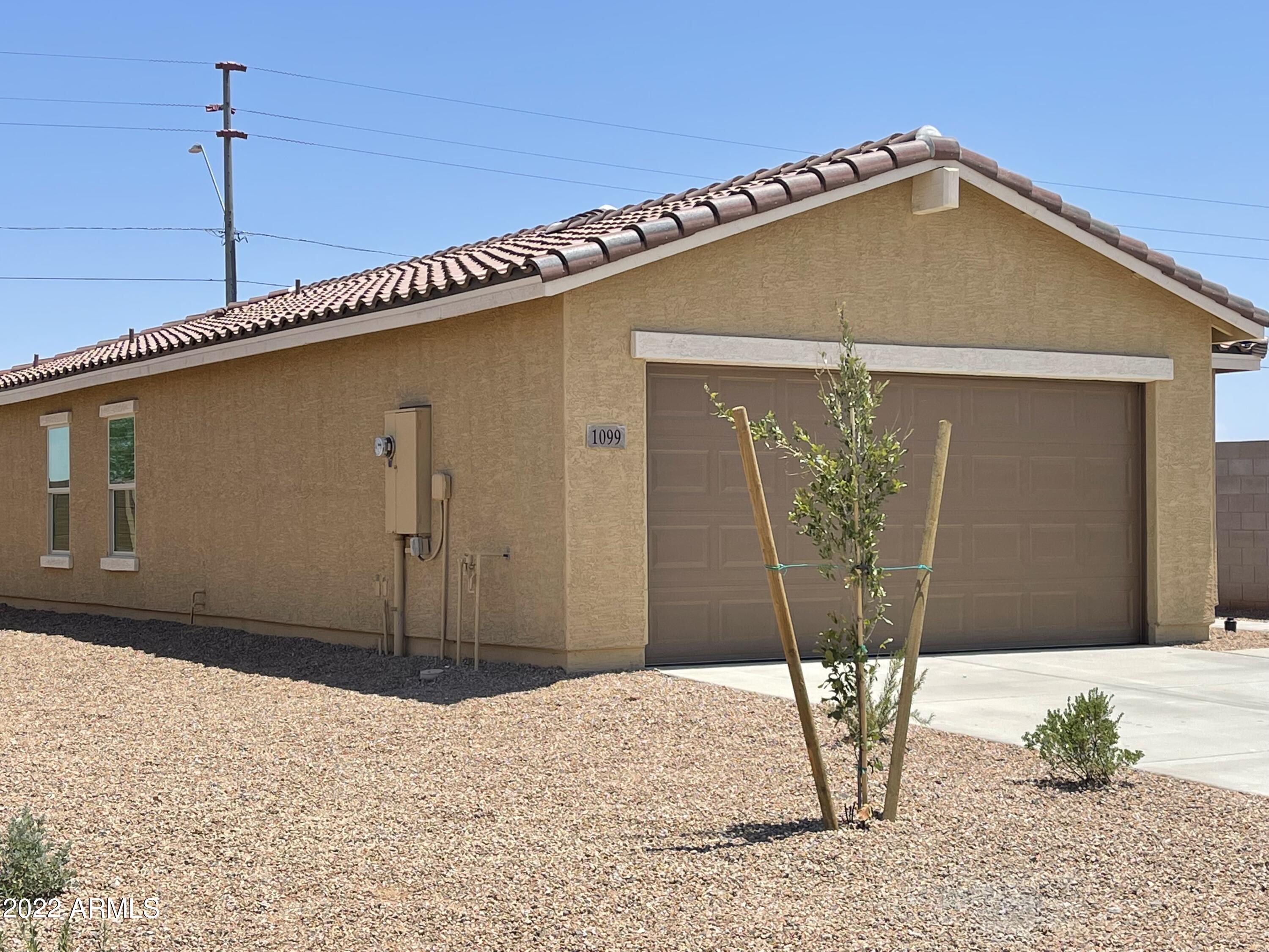 1099 9th Place Coolidge, AZ 85128 - Photo 3 of 11 a front view of a house