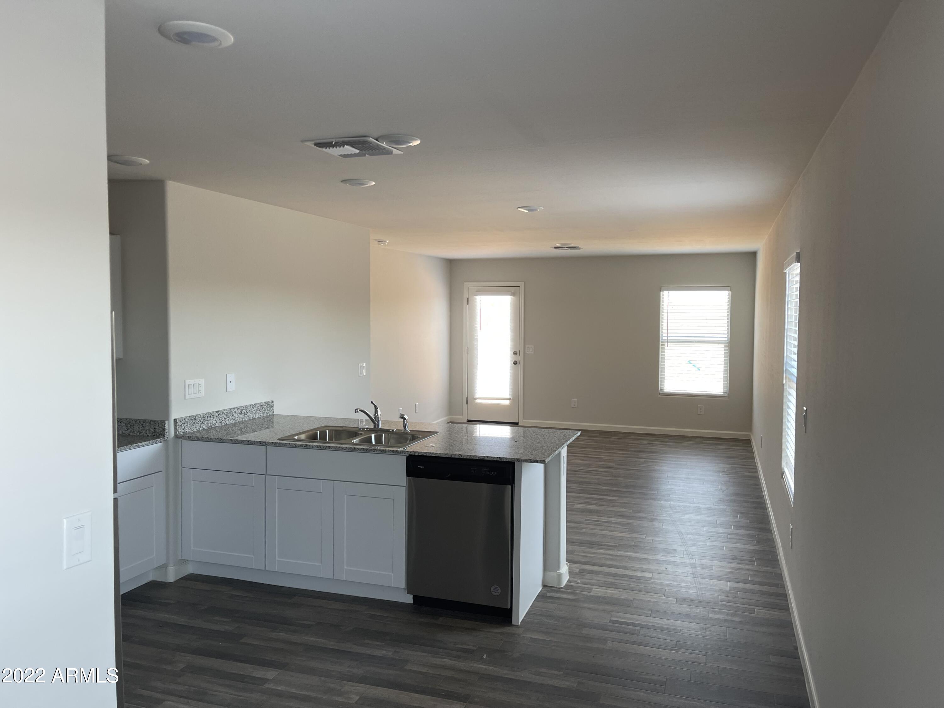 1099 9th Place Coolidge, AZ 85128 - Photo 4 of 11 a kitchen with granite countertop a sink and cabinets