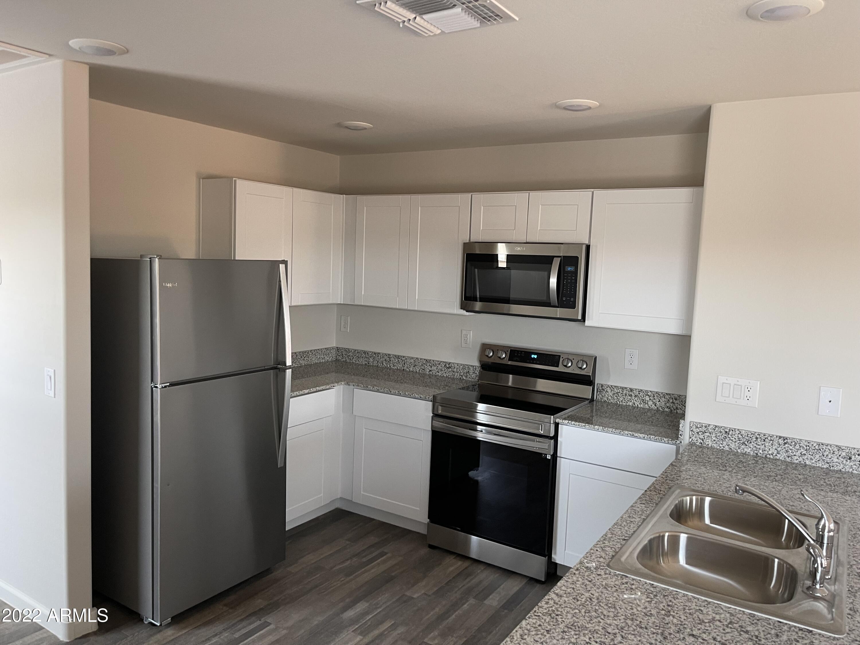 1099 9th Place Coolidge, AZ 85128 - Photo 5 of 11 a kitchen with a refrigerator stove and microwave