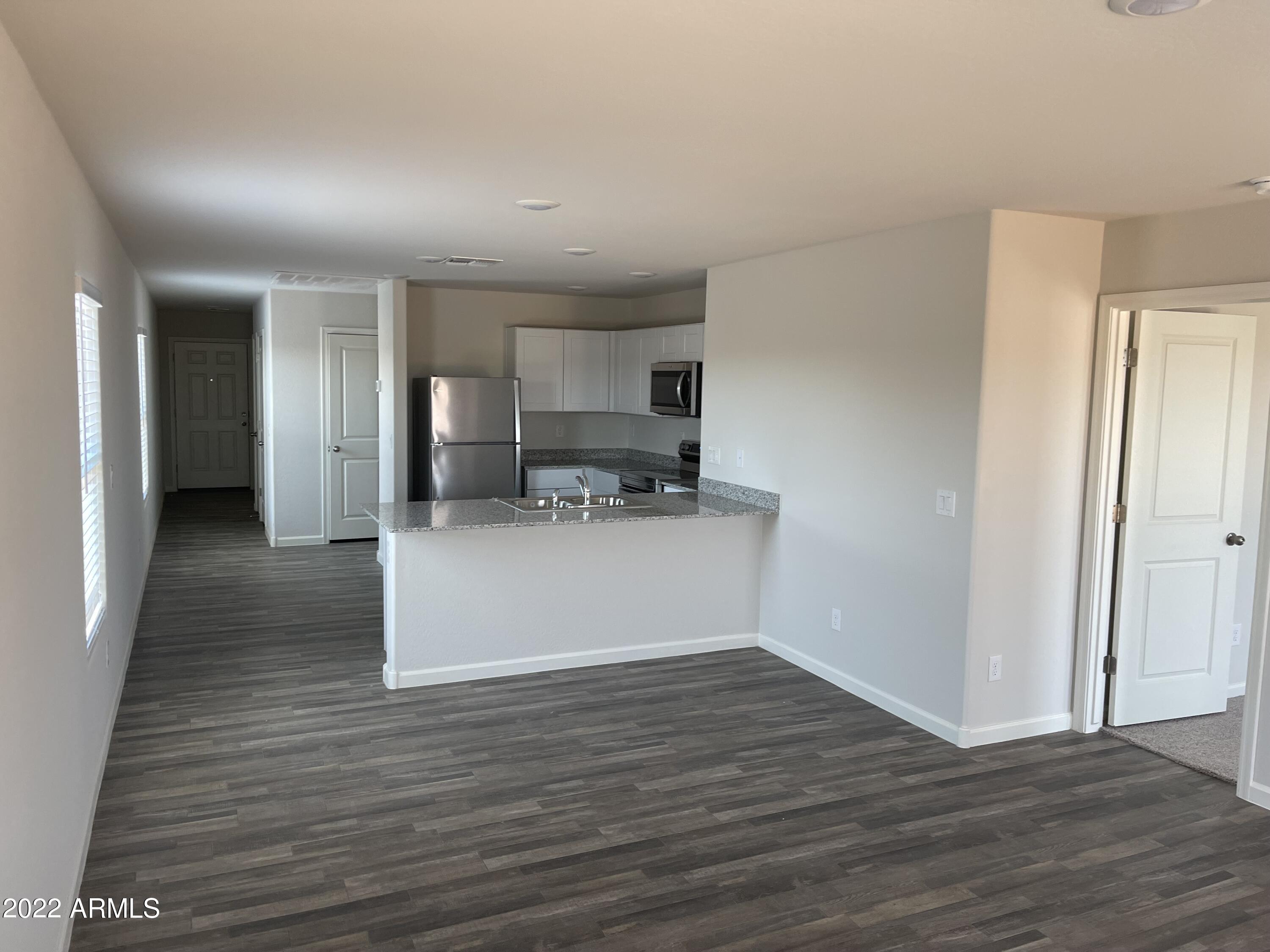 1099 9th Place Coolidge, AZ 85128 - Photo 7 of 11 a view of a kitchen with wooden floor and a space