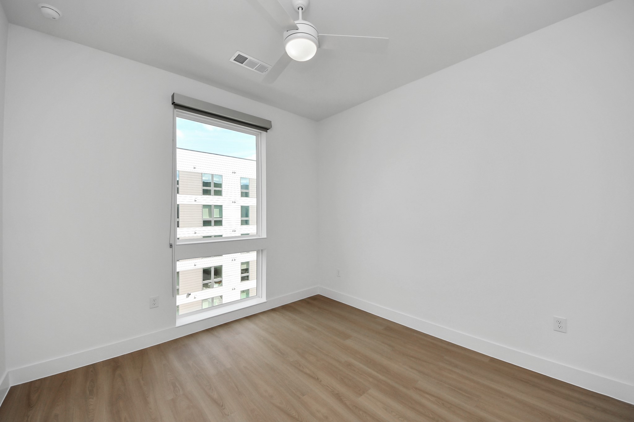 2810 Riverby Road, Unit 225 Houston, TX 77020 - Photo 13 of 47 an empty room with wooden floor cabinet and windows
