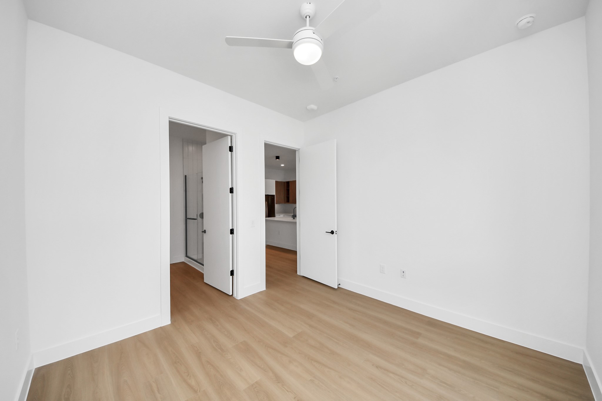 2810 Riverby Road, Unit 225 Houston, TX 77020 - Photo 15 of 47 an empty room with wooden floor and ceiling fan