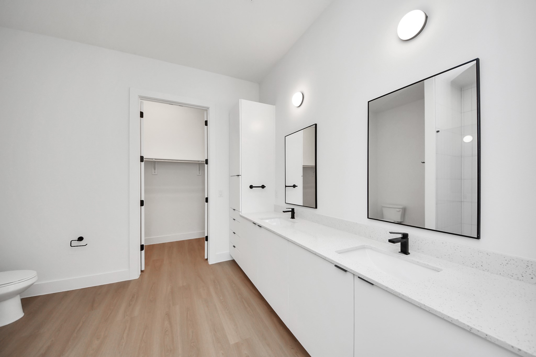 2810 Riverby Road, Unit 225 Houston, TX 77020 - Photo 26 of 47 a bathroom with a double vanity sink and mirror with toilet