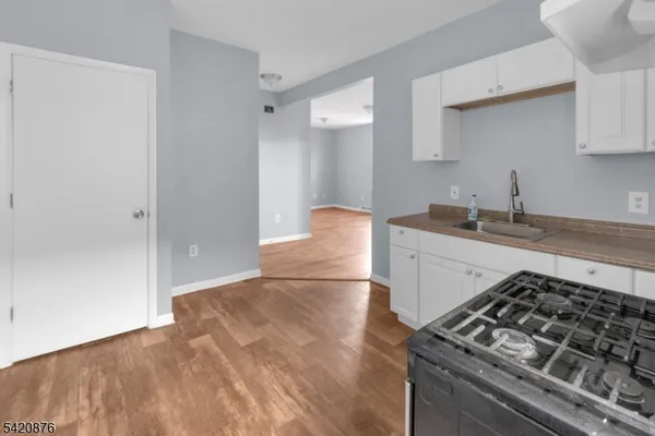 a kitchen with a sink and a stove top oven