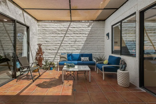 a kitchen with granite countertop a refrigerator and a sink