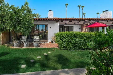 a patio with a table and chairs