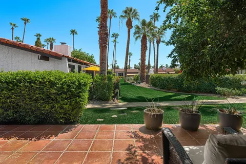a view of a table and chairs under an umbrella