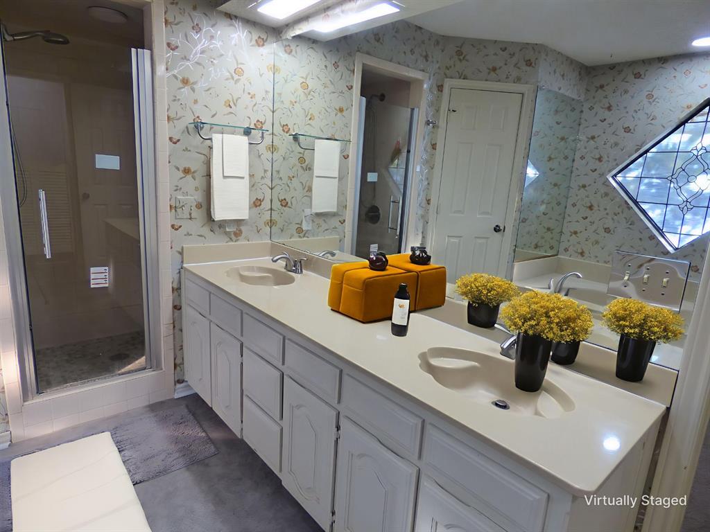 1506 East Peters Colony Road Carrollton, TX 75007 - Photo 17 of 33 a bathroom with a double vanity sink mirror and shower