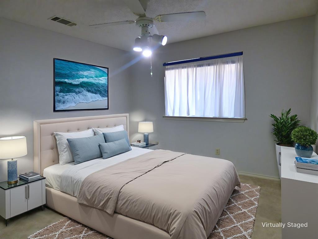 1506 East Peters Colony Road Carrollton, TX 75007 - Photo 20 of 33 a bedroom with a large bed and a chandelier