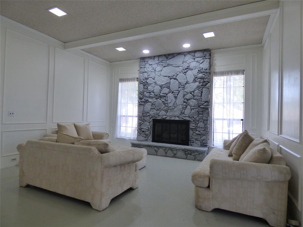 1506 East Peters Colony Road Carrollton, TX 75007 - Photo 2 of 33 a living room with furniture and a fireplace