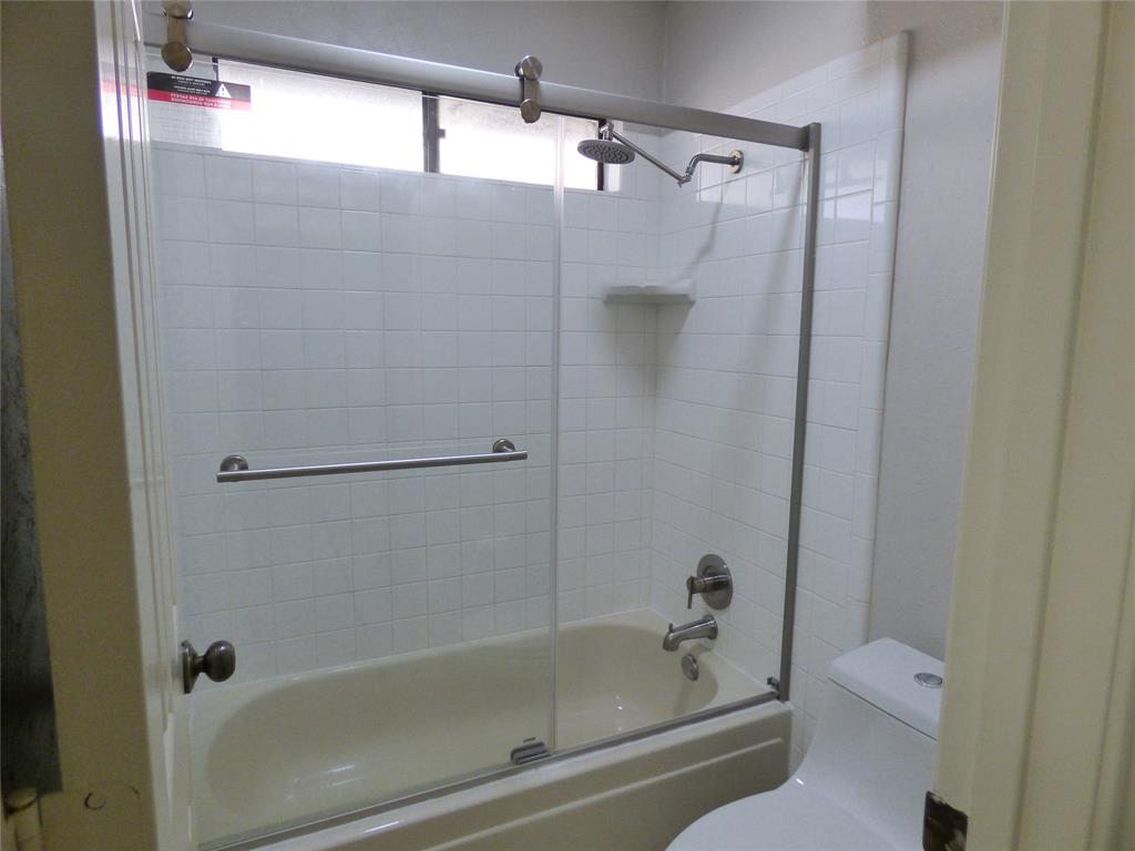 1506 East Peters Colony Road Carrollton, TX 75007 - Photo 27 of 33 a bathroom with a shower and a toilet