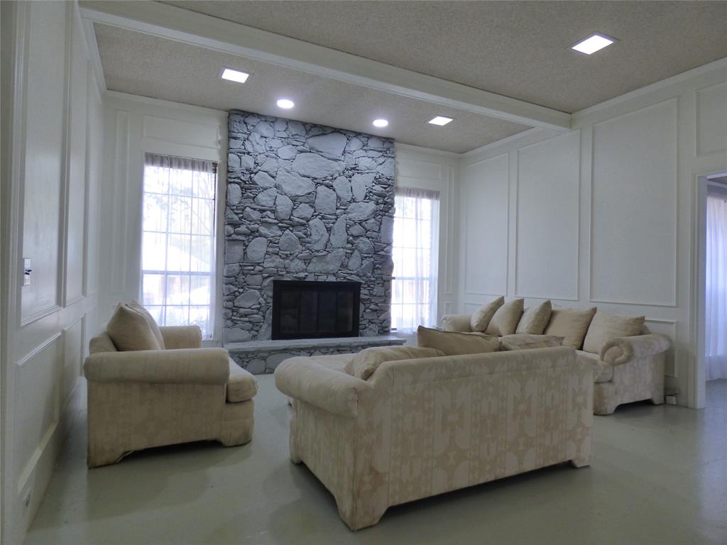 1506 East Peters Colony Road Carrollton, TX 75007 - Photo 3 of 33 a living room with furniture and a fireplace