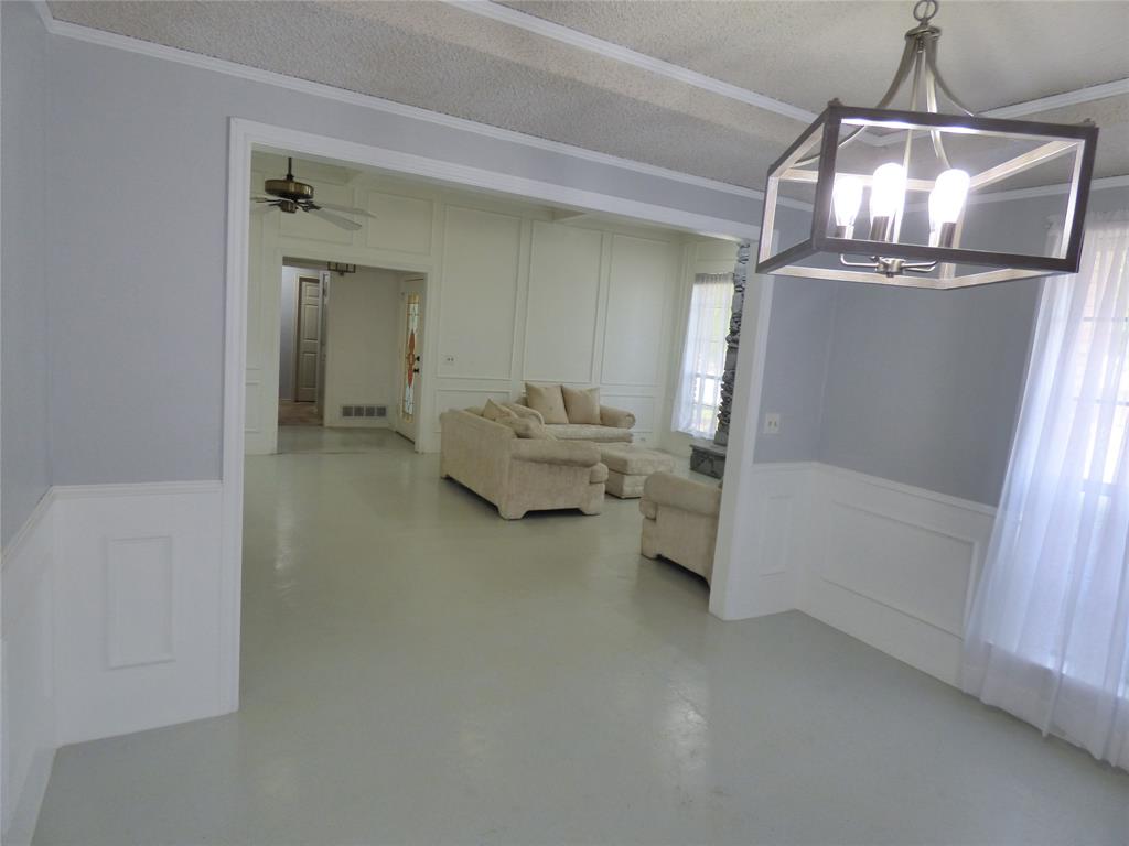 1506 East Peters Colony Road Carrollton, TX 75007 - Photo 7 of 33 a living room with furniture and a chandelier