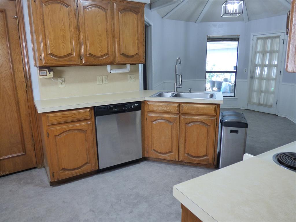 1506 East Peters Colony Road Carrollton, TX 75007 - Photo 9 of 33 a kitchen with a sink cabinets and a window