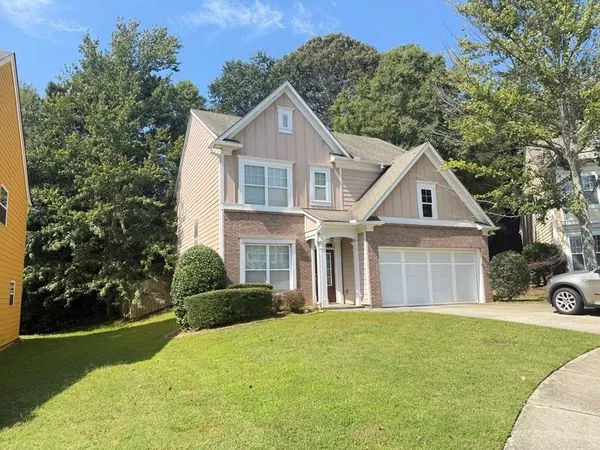 a front view of a house with a garden