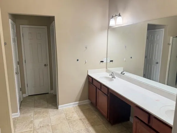 a bathroom with a double vanity sink a mirror and a