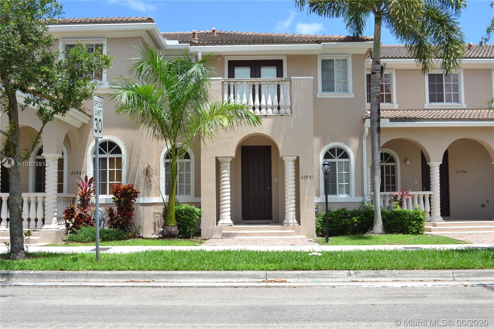 27951 Southwest 140th Avenue Homestead, FL 33032 - Photo 1 of 27 a front view of a house with a garden