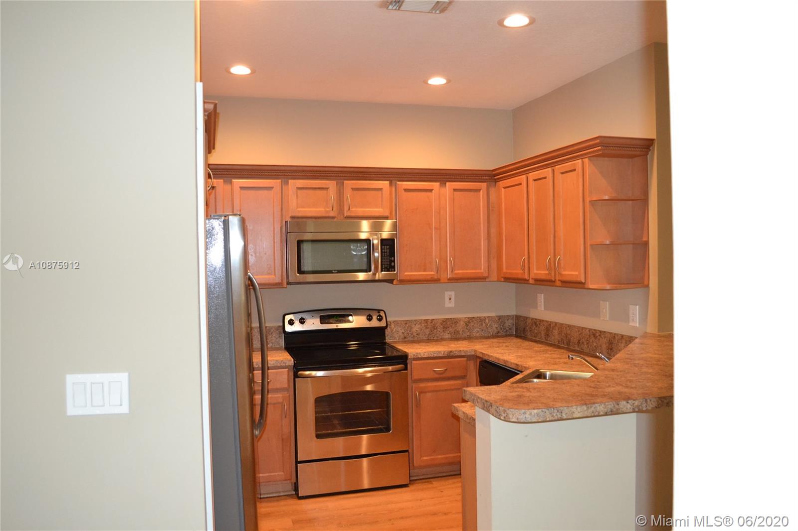 27951 Southwest 140th Avenue Homestead, FL 33032 - Photo 12 of 27 a kitchen that has a sink and a stove in it