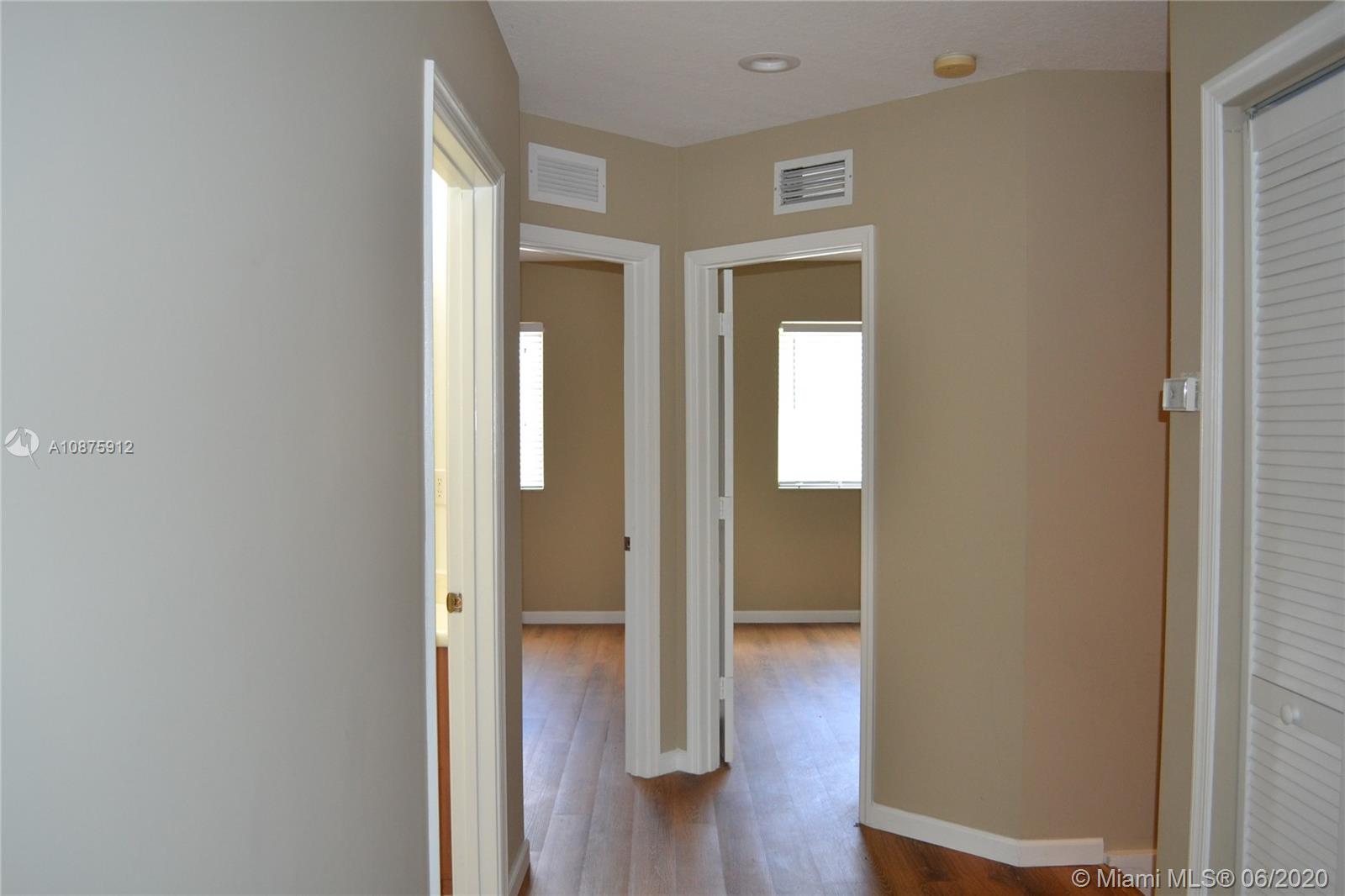 27951 Southwest 140th Avenue Homestead, FL 33032 - Photo 14 of 27 a view of a hallway with wooden floor