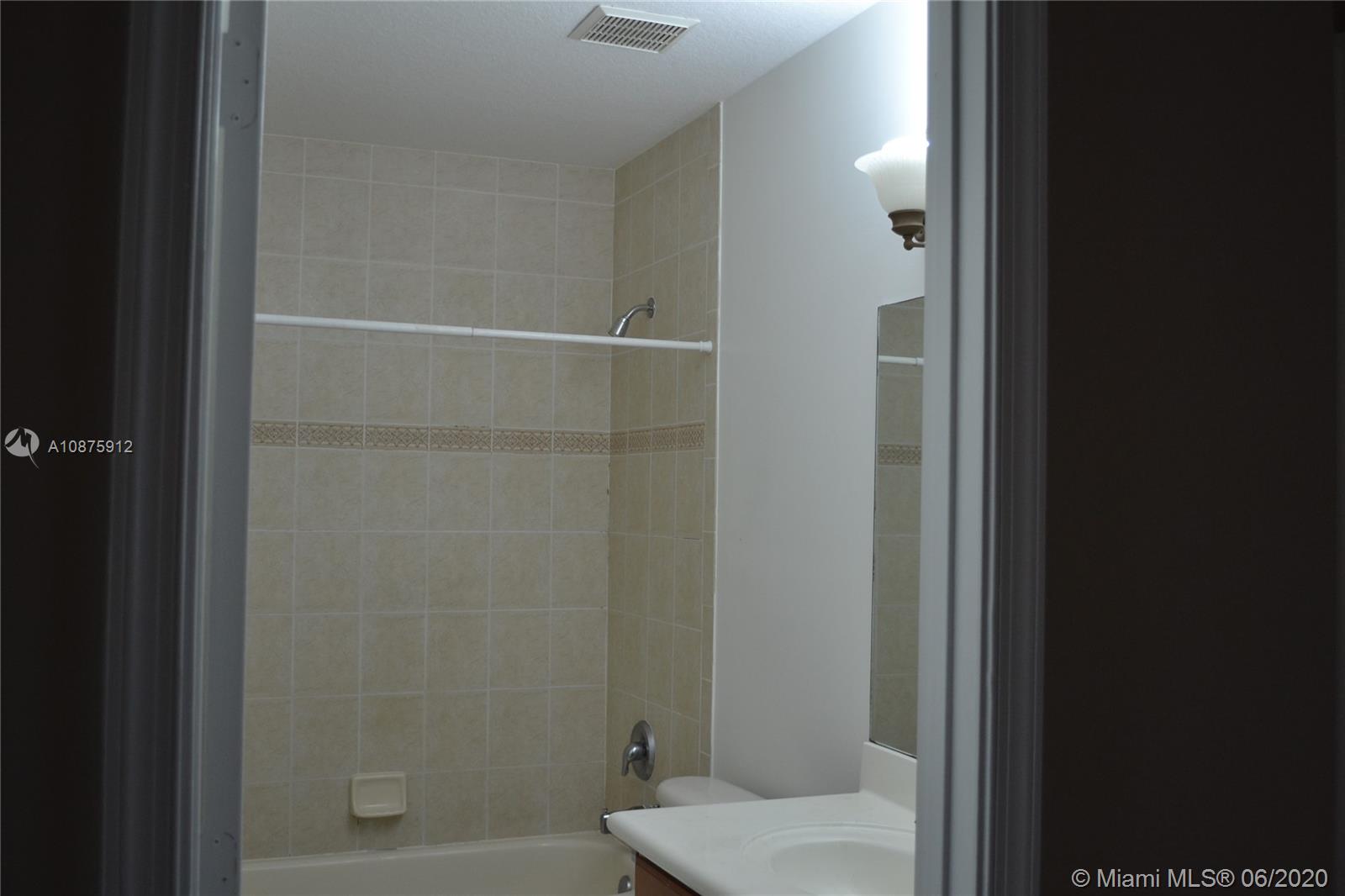 27951 Southwest 140th Avenue Homestead, FL 33032 - Photo 18 of 27 a bathroom with a shower and toilet