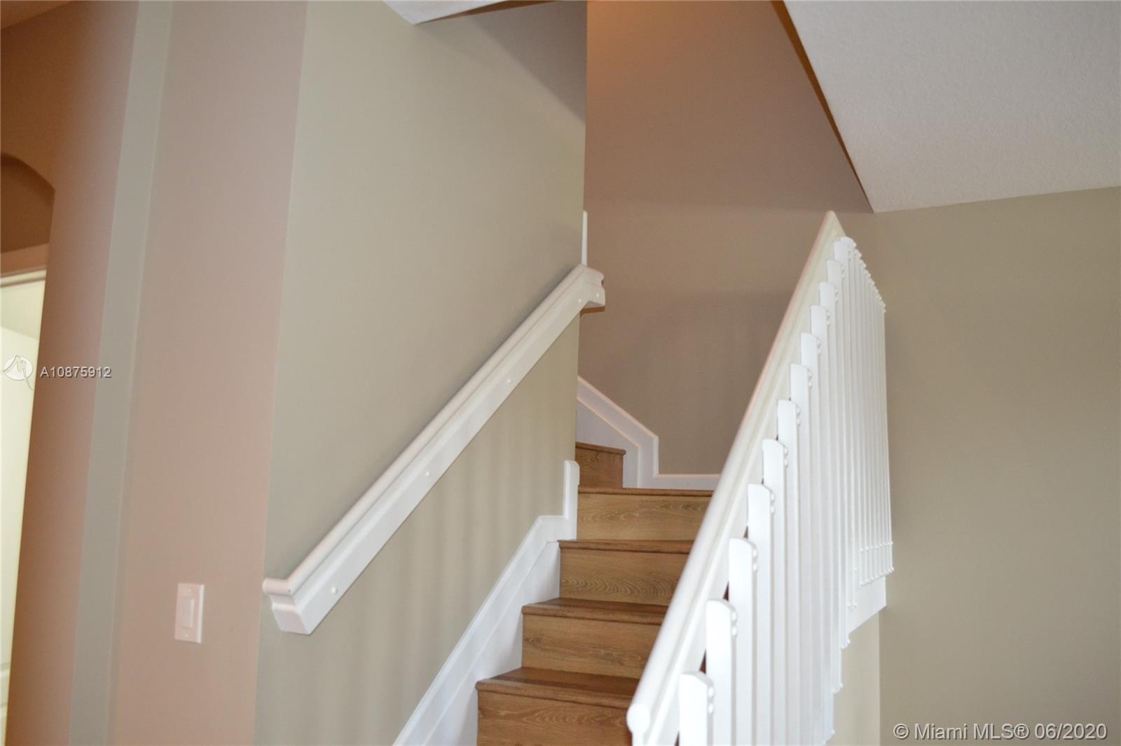 27951 Southwest 140th Avenue Homestead, FL 33032 - Photo 19 of 27 a view of staircase with railing and white walls