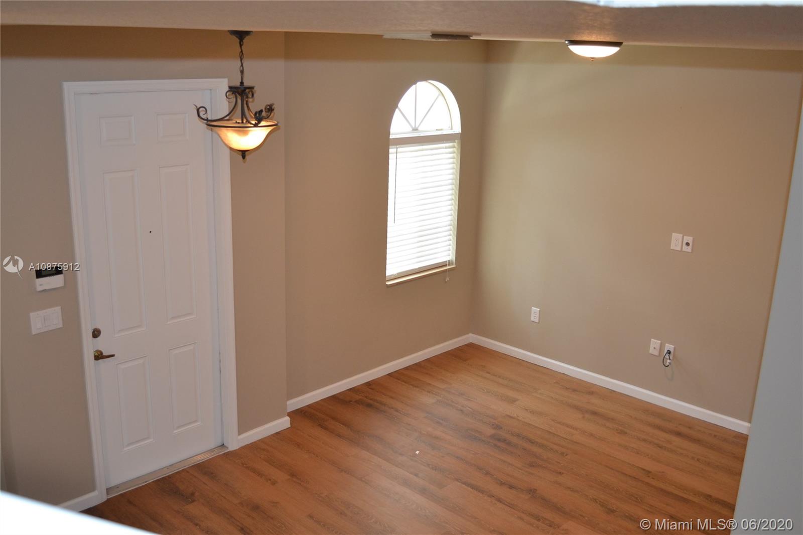 27951 Southwest 140th Avenue Homestead, FL 33032 - Photo 5 of 27 an empty room with wooden floor and window
