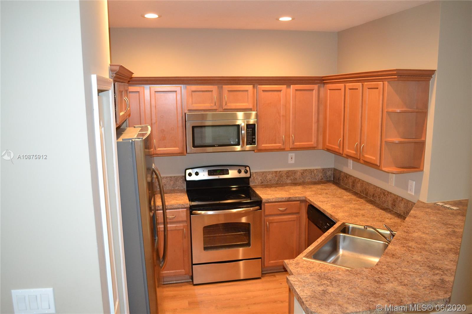 27951 Southwest 140th Avenue Homestead, FL 33032 - Photo 9 of 27 a kitchen with a sink cabinets and stainless steel appliances