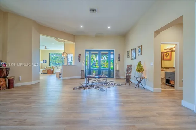 a view of empty room with window and wooden floor