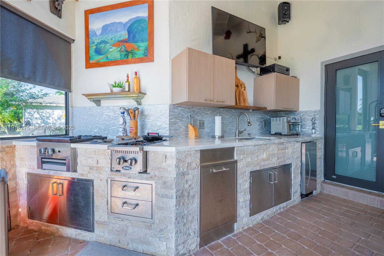13372 Southwest 40th Street Davie, FL 33330 - Photo 18 of 22 a kitchen with stainless steel appliances granite countertop a stove and a refrigerator