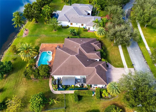 an aerial view of house with yard swimming pool and outdoor seating