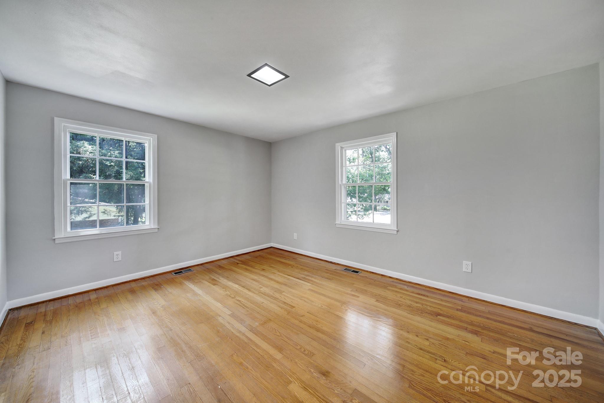 967 State Rd S-29-376 Lancaster, SC 29720 - Photo 19 of 33 an empty room with wooden floor and windows
